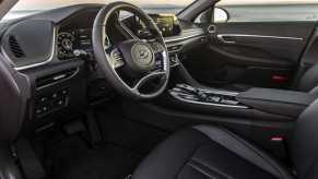 Interior shot of a 2022 Hyundai Sonata Hybrid, a great rideshare car, with a black interior