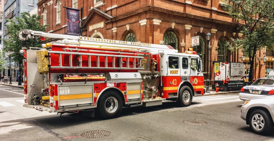 A fire engine truck driving through a city intersection.