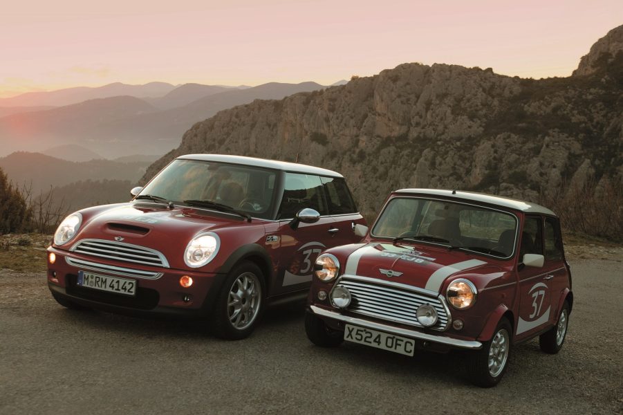 A red 2004 Mini Cooper S next to a red-with-white-stripes 1964 Mini Cooper S in the Monte Carlo hills