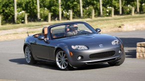 Silver 2006 Mazda Miata Sports Roadster going through a corner