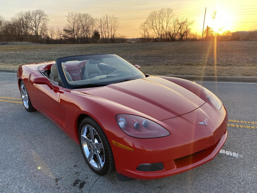 A red 2008 Chevrolet Corvette 3LT Convertible in a parking lot with its top down