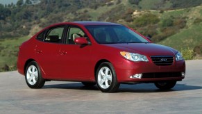 Front 3/4 of red 2009 Hyundai Elantra in mountain setting