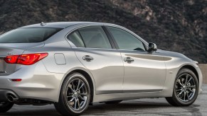 a gray 2017 Infiniti Q50 30t Signature Edition is parked to show off it its incredible design and muscular body lines.