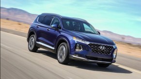 A blue 2019 Hyundai Santa Fe driving outside.