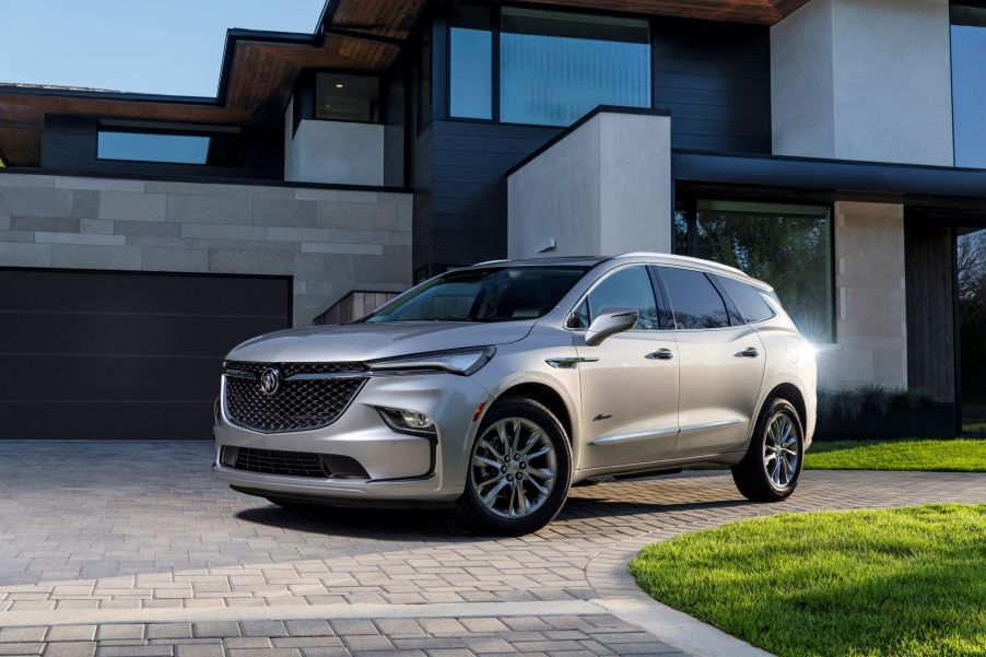 The 2022 Buick Enclave Avenir premium midsize SUV parked on a cobblestone driveway