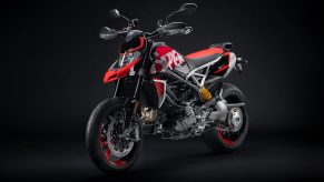 A red-black-and-white Graffiti-liveried 2022 Ducati Hypermotard 950 RVE in a black studio