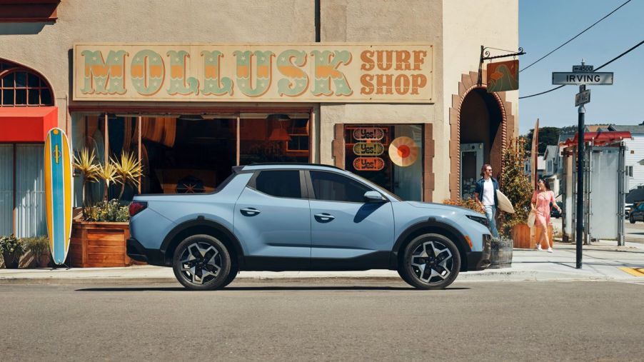 2022 Hyundai Santa Cruz Limited in Blue Stone parked in front of a shop on Irving Street