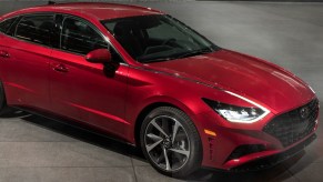 Red 2022 Hyundai Sonata parked at night with LED lighting on in the front