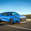 The 2022 Hyundai Veloster N performance hatchback speeding down a highway