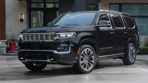 The 2022 Jeep Grand Wagoneer full-size luxury SUV model parked on a slate plaza