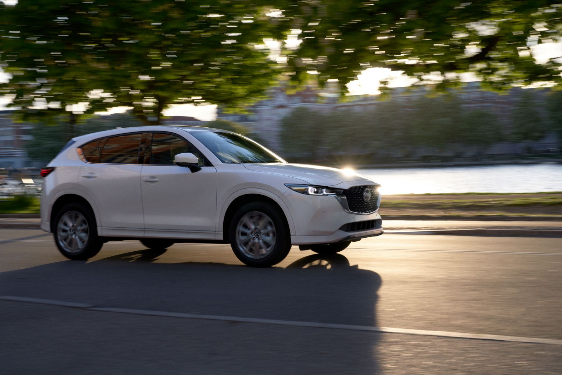 2022 Mazda CX-5 Turbo Signature in white driving past water