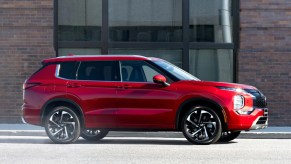 A red 2022 Mitsubishi Outlander parked in a city.