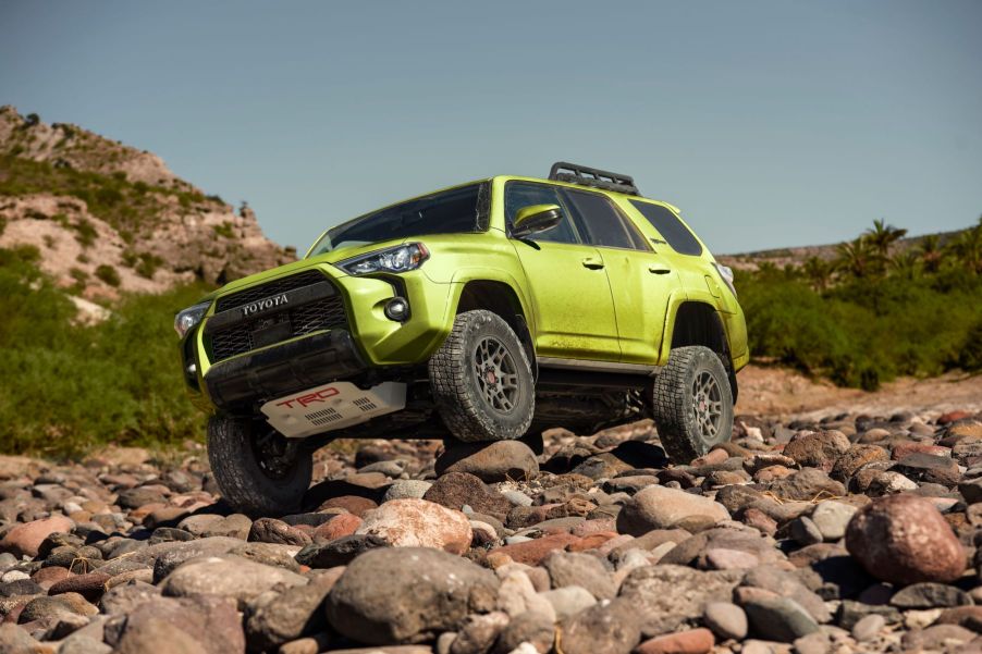 2022 Toyota 4Runner TRD Pro midsize off-road SUV in Lime climbing over rocks