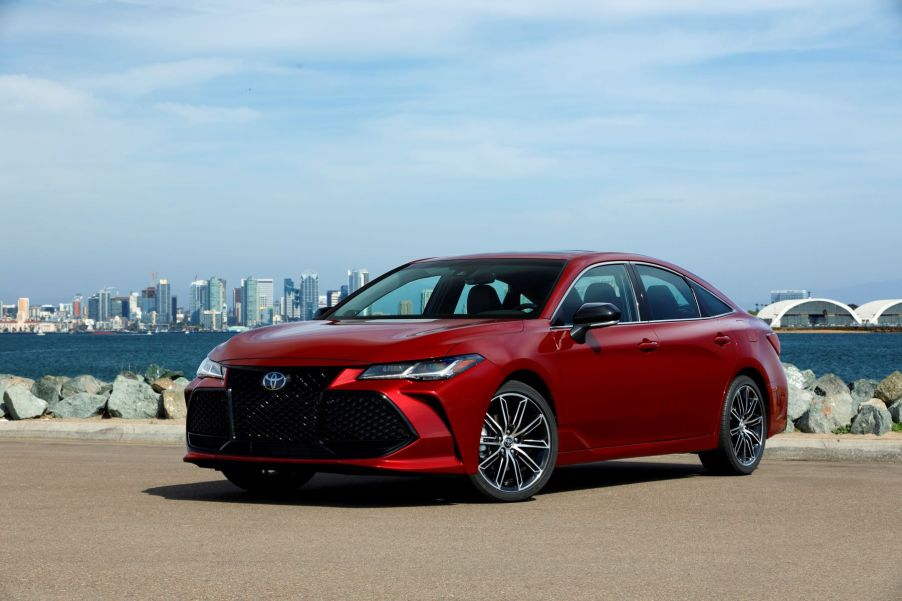 The 2022 Toyota Avalon Touring full-size sedan parked on a beach