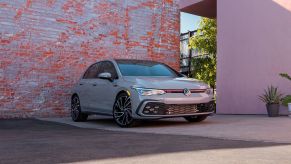 2022 Volkswagen Golf GTI Autobahn parked in front of a worn brick wall