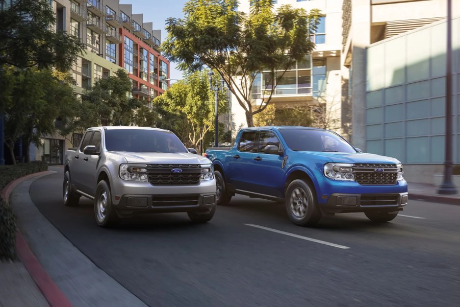 A pair of Ford Maverick compact trucks navigate an urban environment.