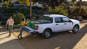 The 2022 Ford Maverick XL is a basic compact pickup truck. Here it has soil loaded into its bed.