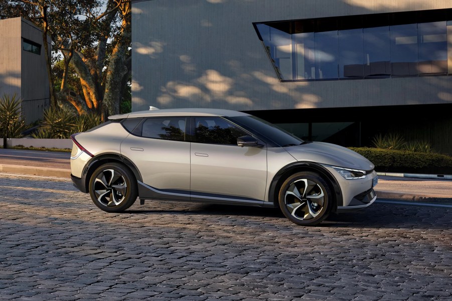 A silver 2022 Kia EV6 model sits outside of a buidling.