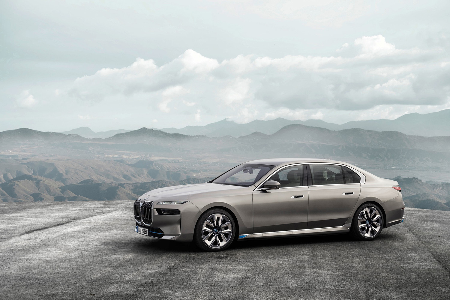 Driver side shot of the all-new 2023 BMW i7 Luxury EV Sedan in the mountains