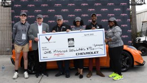 Rick Hendrick, with his grandson, Barrett-Jackson chairman and CEO Craig Jackson, Thurgood Marshall College Fund representatives and the 2023 Corvette Z06 convertible.