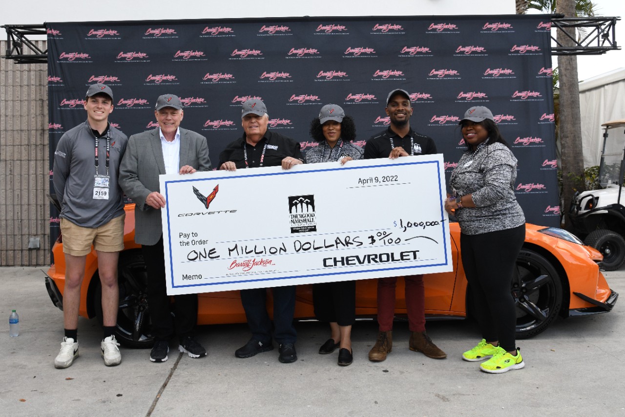 Rick Hendrick, with his grandson, Barrett-Jackson chairman and CEO Craig Jackson, Thurgood Marshall College Fund representatives and the 2023 Corvette Z06 convertible.