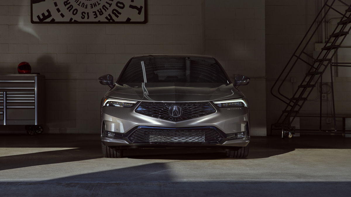 Dimly lit shot of a 2023 Acura Integra, cost unknown, parked in a garage