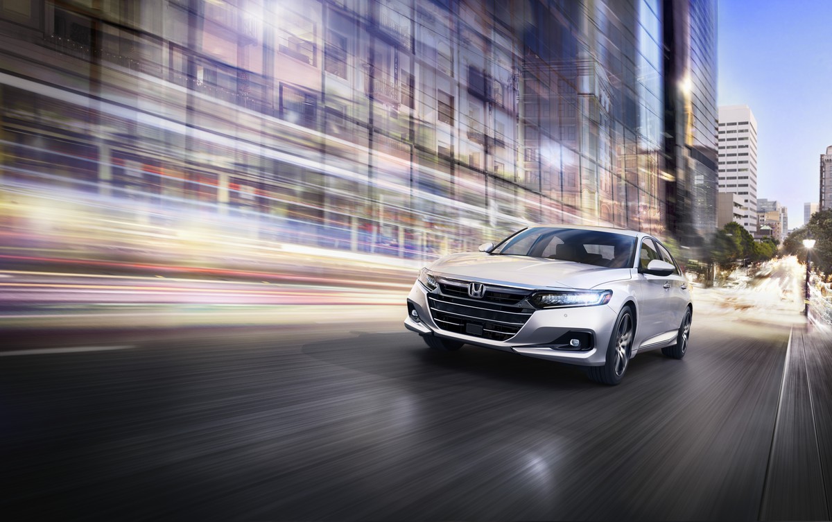 Silver 2022 Honda Accord sedan in action driving along a wet city street at night; the 2023 Honda Accord will likely look similar