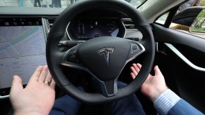 Dan Kiely, CEO of Voxpro, takes his hands off the wheel of his Tesla Model S car at a launch event for the MobilityX self-driving conference, a gathering of global autonomous vehicle leaders, in Dublin.