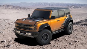 A yellow 2022 Ford Bronco Raptor in the desert.