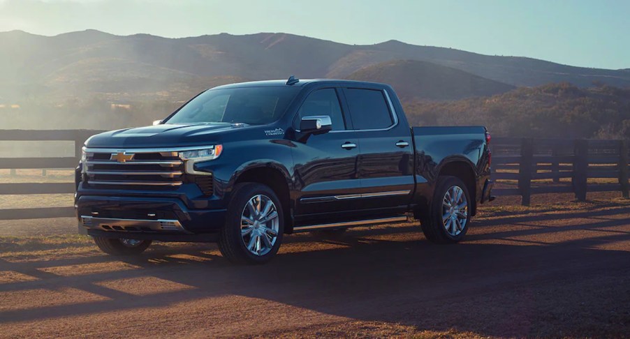 A blue Chevrolet Silverado 1500 truck is parked.