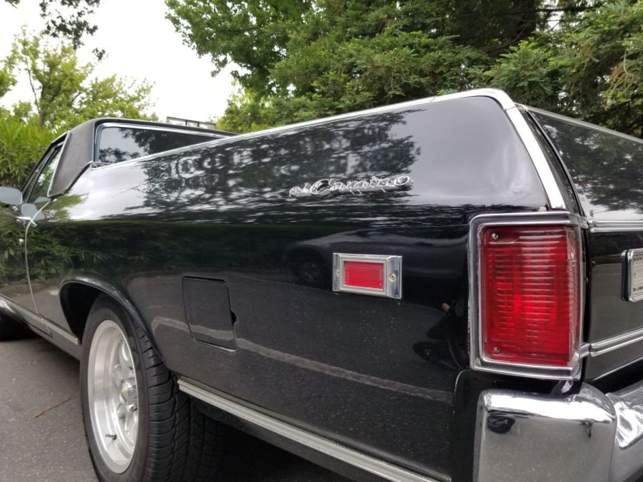 A black back end of a Chevy El Camino that is a coupe utility ute versus a pickup truck.