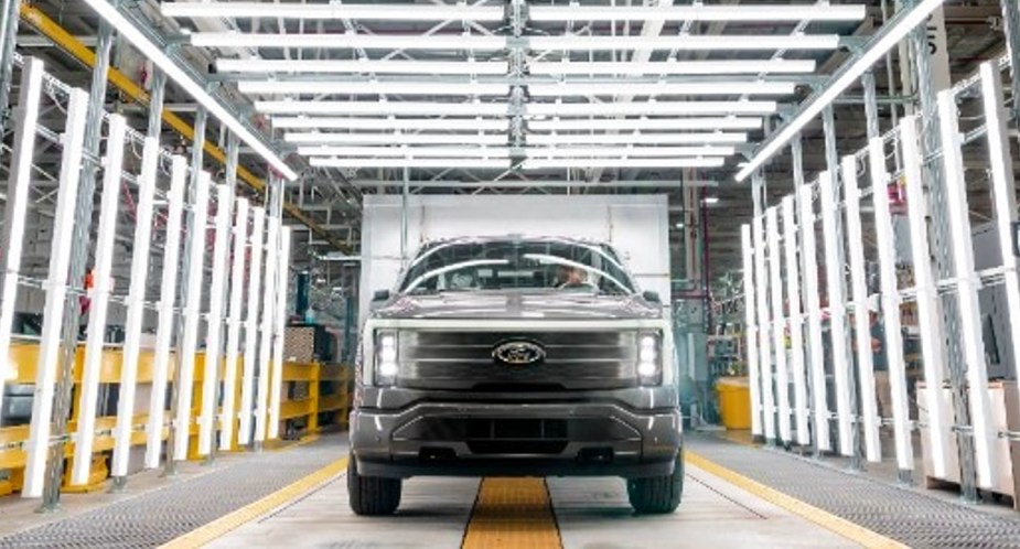 A gray 2022 Ford F-150 Lightning electric pickup truck is parked.