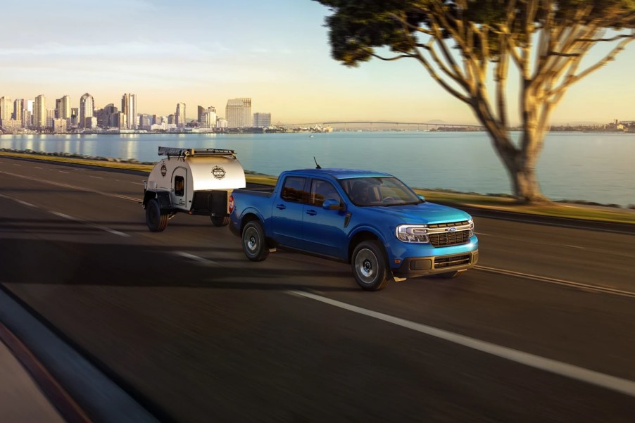 A blue Ford Maverick demonstrates its towing capability.