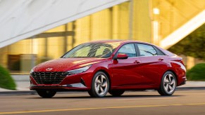 A red 2022 Hyundai Elantra driving at sunset