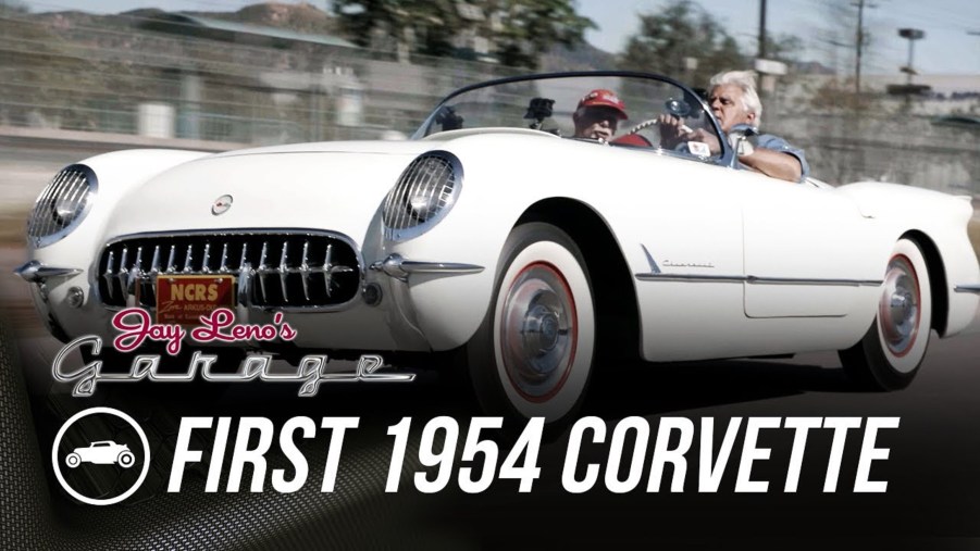 Jay Leno driving a white 1954 Chevrolet Corvette on the streets of LA