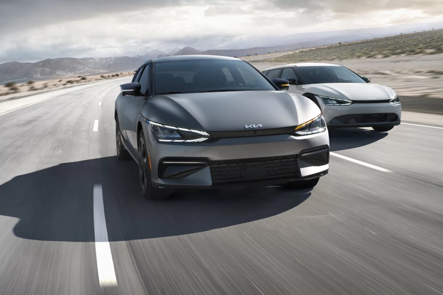 A pair of 2022 Kia EV6 electric SUVs show off their performance in a desert habitat.