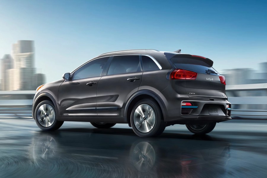 A dark gray 2022 Kia Niro in front of a city.