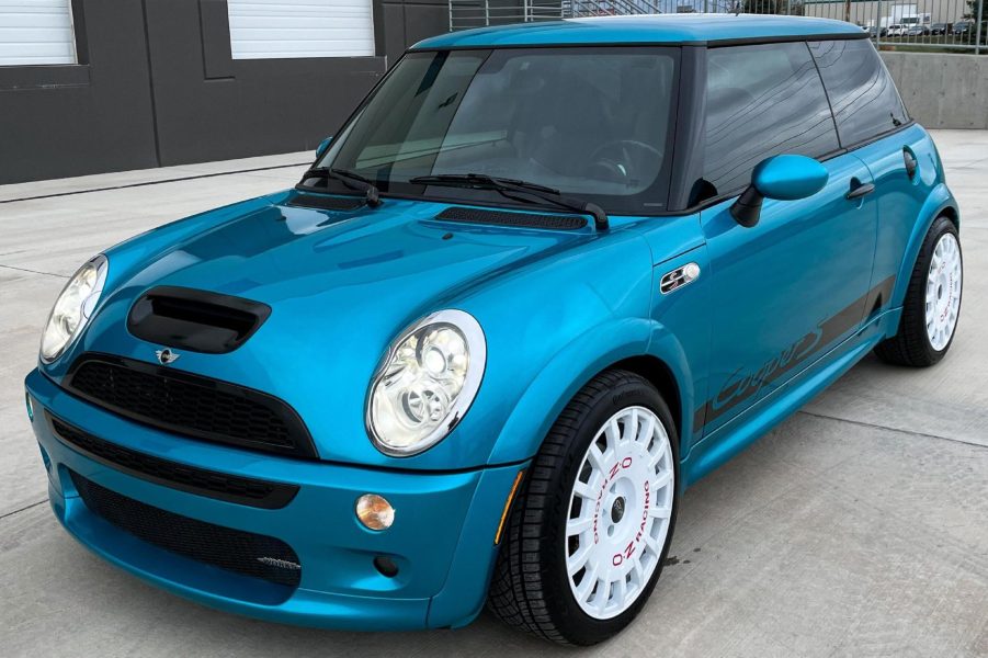 A blue modified 2005 Mini Cooper S with JCW kit in a parking lot