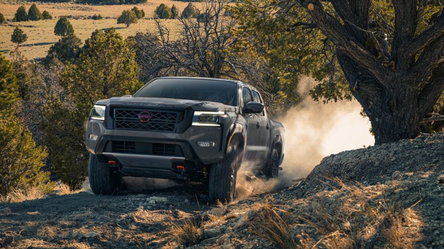 A 2022 Nissan Frontier drive on a remote road as a mid-size truck.