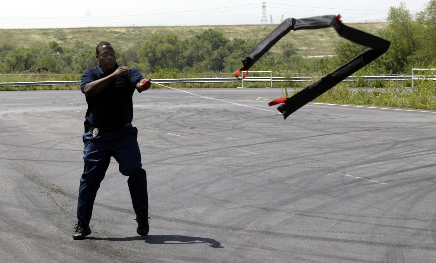 Police officer deploying stop sticks to end pursuit