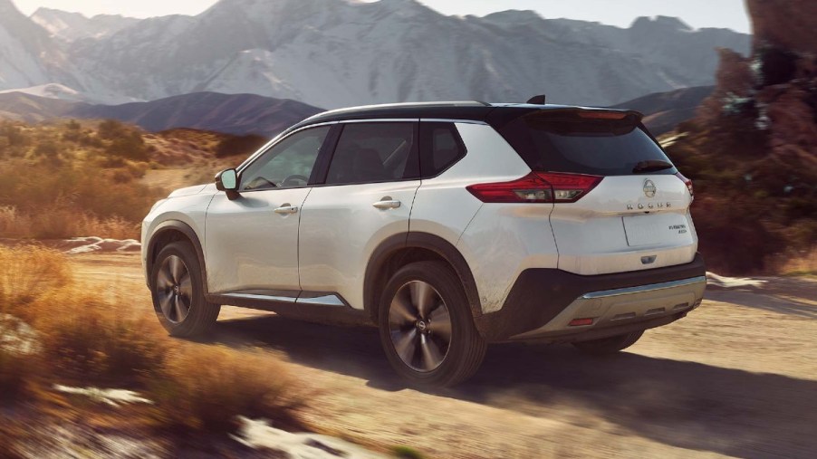 Pearl White TriCoat 2022 Nissan Rogue with mountains in the background