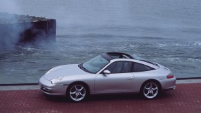 Silver Porsche 996 911 Targa driving in front of the ocean