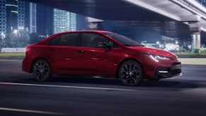 Red 2022 Toyota Corolla driving under an overpass