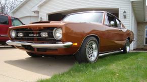 Front grille of the Savage GT muscle car parked in front of a suburban home.