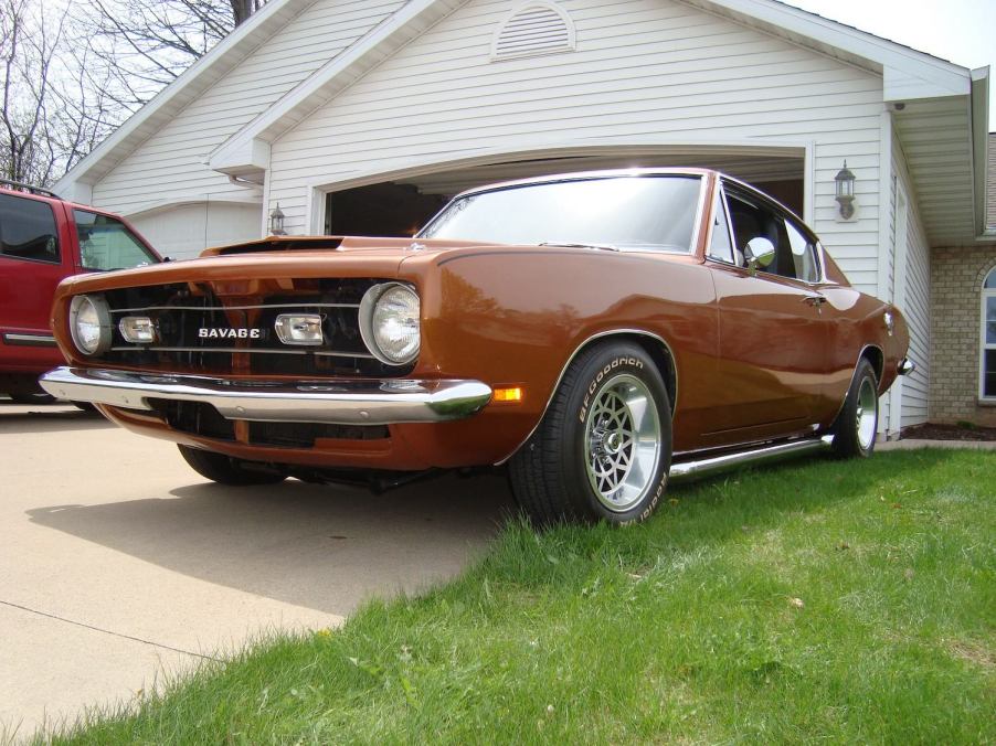 Front grille of the Savage GT muscle car parked in front of a suburban home.