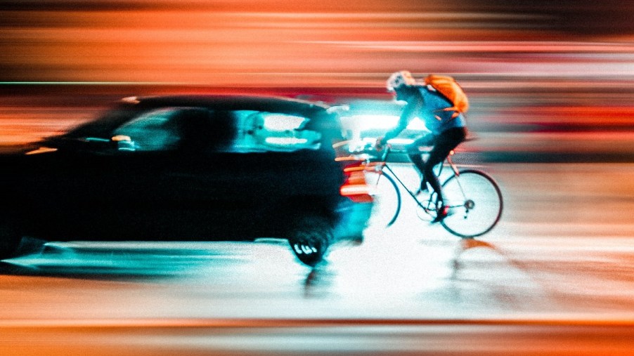 Side view of a car and a bike, highlighting how bikes don't slow down car traffic and cause congestion