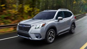 A silver 2022 Subaru Forester drivin