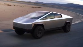 A silver Tesla Cybertruck is driving on a track.