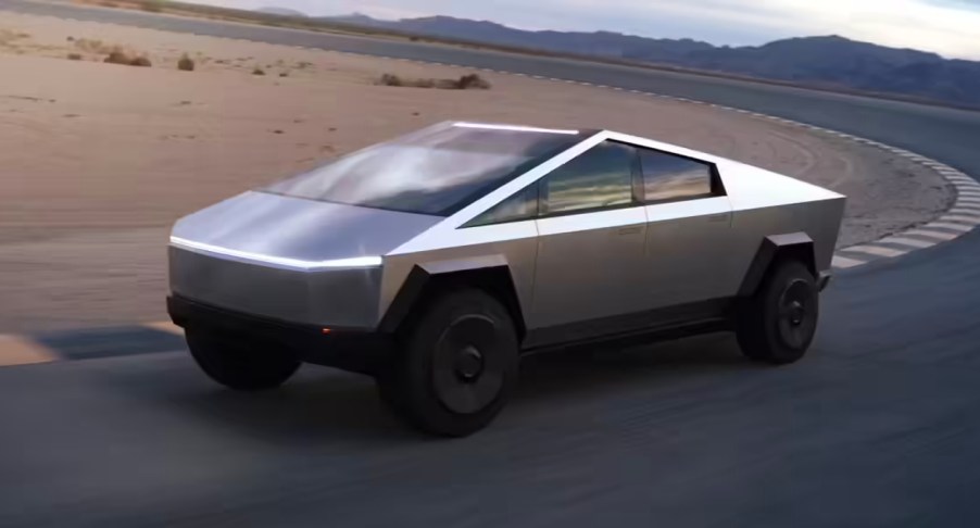 A silver Tesla Cybertruck is driving on a track.