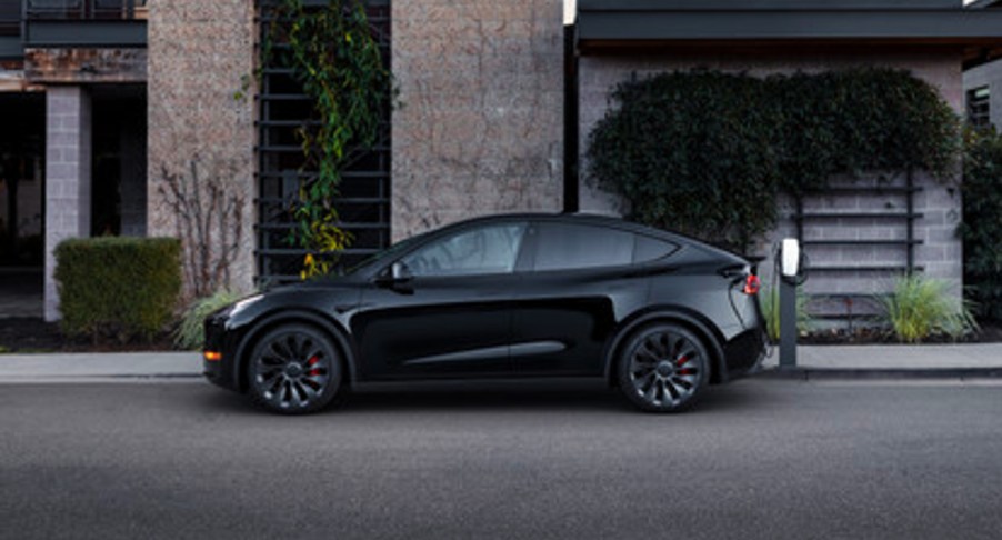 A black 2022 Tesla Model Y electric SUV is parked.